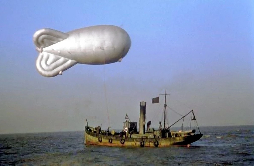 A rare colour photograph of a barrage balloon tethered to a trawler.