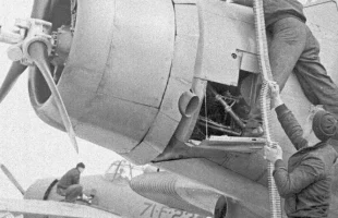 American ground crew load ammunition belts into a Devastator dive bomber at Hatston.